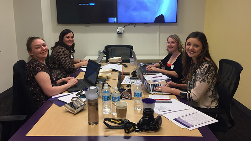Students around table present a case on Yahoo.